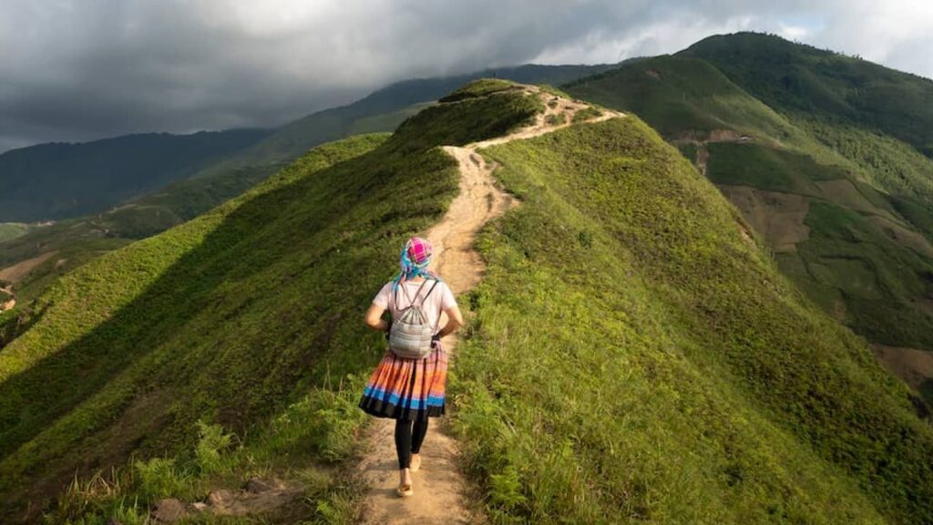 Photo of a woman walking up a hill