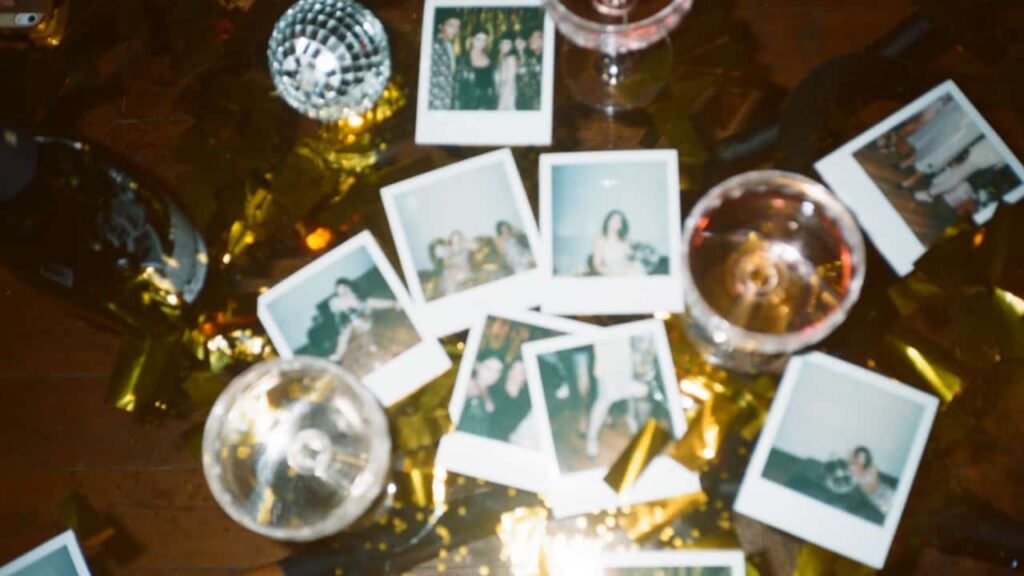 Photo of a new year party table with polaroids and drinks